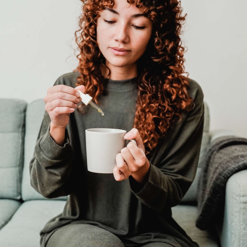 cbd-hemp-oil-woman-taking-cannabis-oil-in-tea-cu-2022-05-17-05-39-00-utc-1-scaled.jpeg